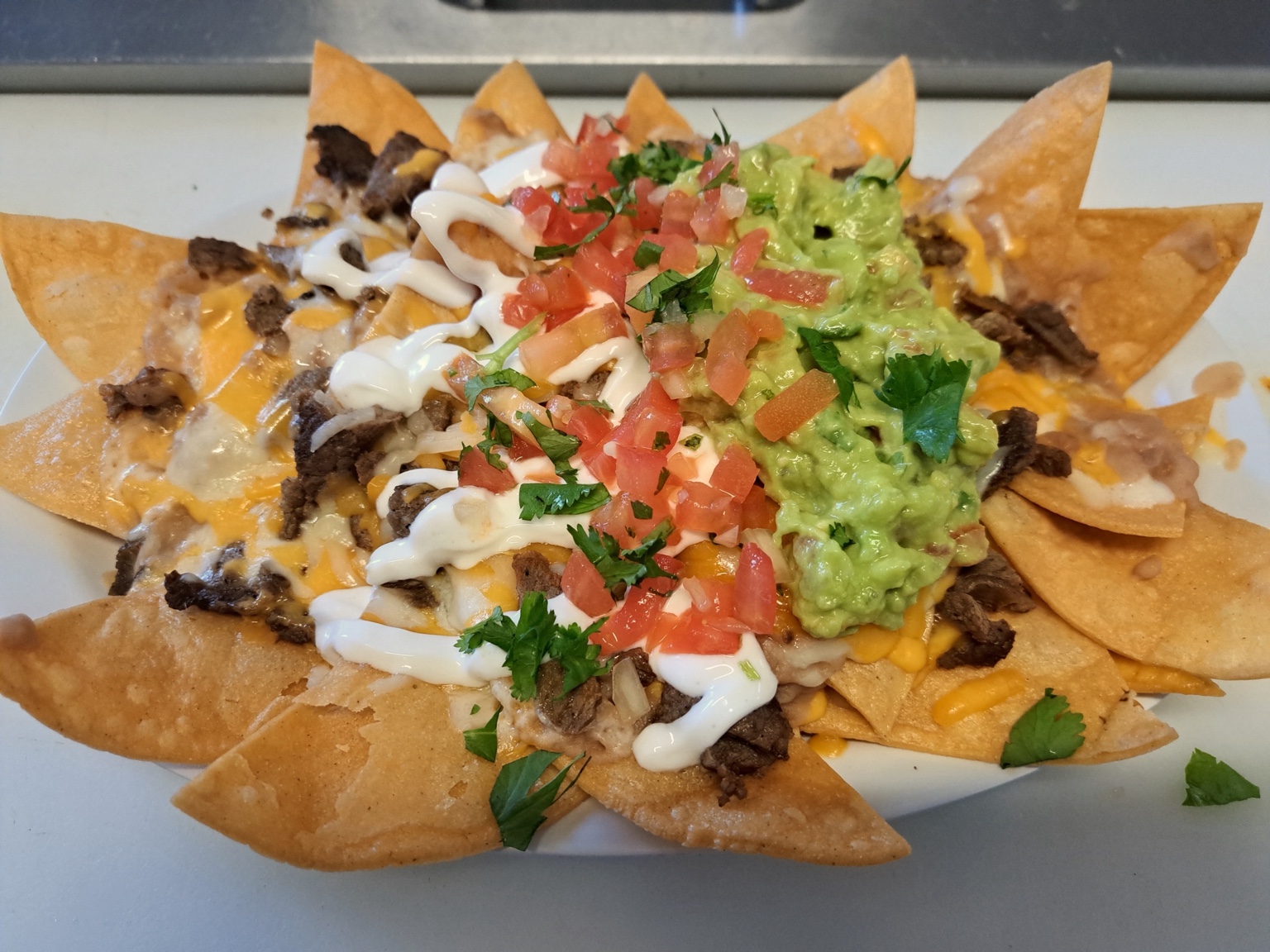 Loaded nachos with guacamole, cheese and pico de gallo